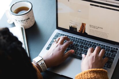 woman typing on laptop keyboard